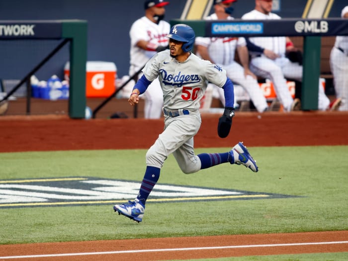 Oct 14, 2020; Arlington, Texas, USA; Los Angeles Dodgers right fielder Mookie Betts (50) scores on a hit by shortstop Corey Seager against the Atlanta Braves during the first inning of game three of the 2020 NLCS at Globe Life Field.
